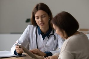 Doctor And Female Patient On Ipad