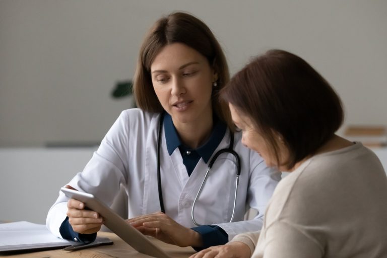 Doctor And Female Patient On Ipad