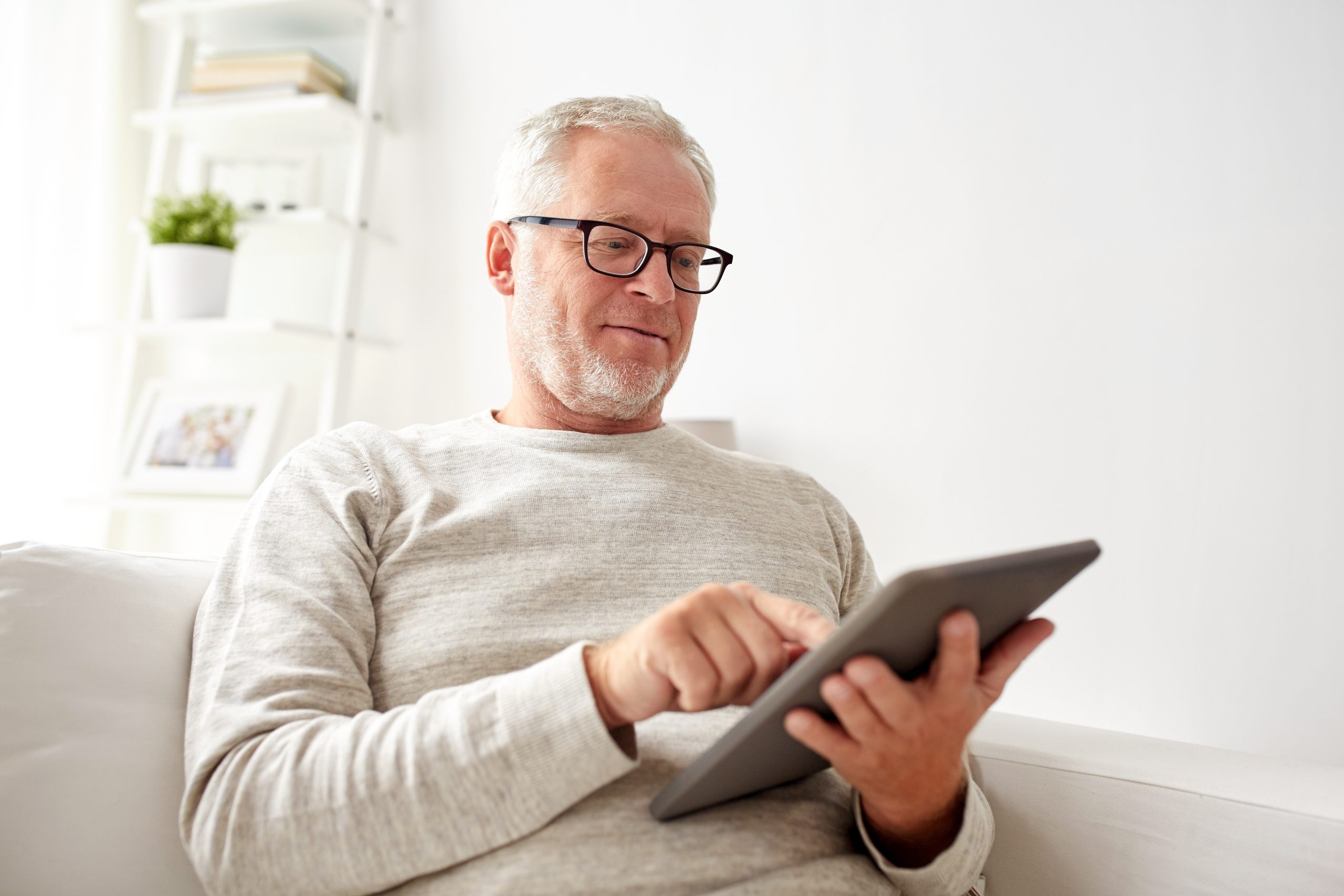 Senior Man With Tablet Pc At Home
