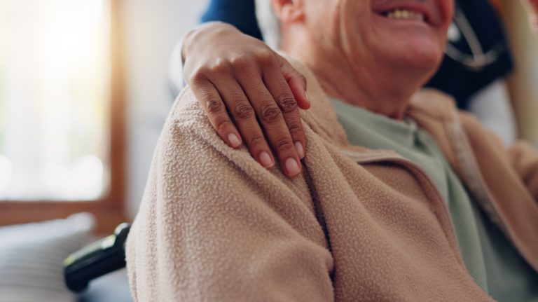 Caregiver, Helping Hand And Senior Man With Support In Retirement, Nursing Home Or Empathy For Kindness. Elderly Care, Nurse And Hands On Shoulder Together And Healthcare Service In Apartment
